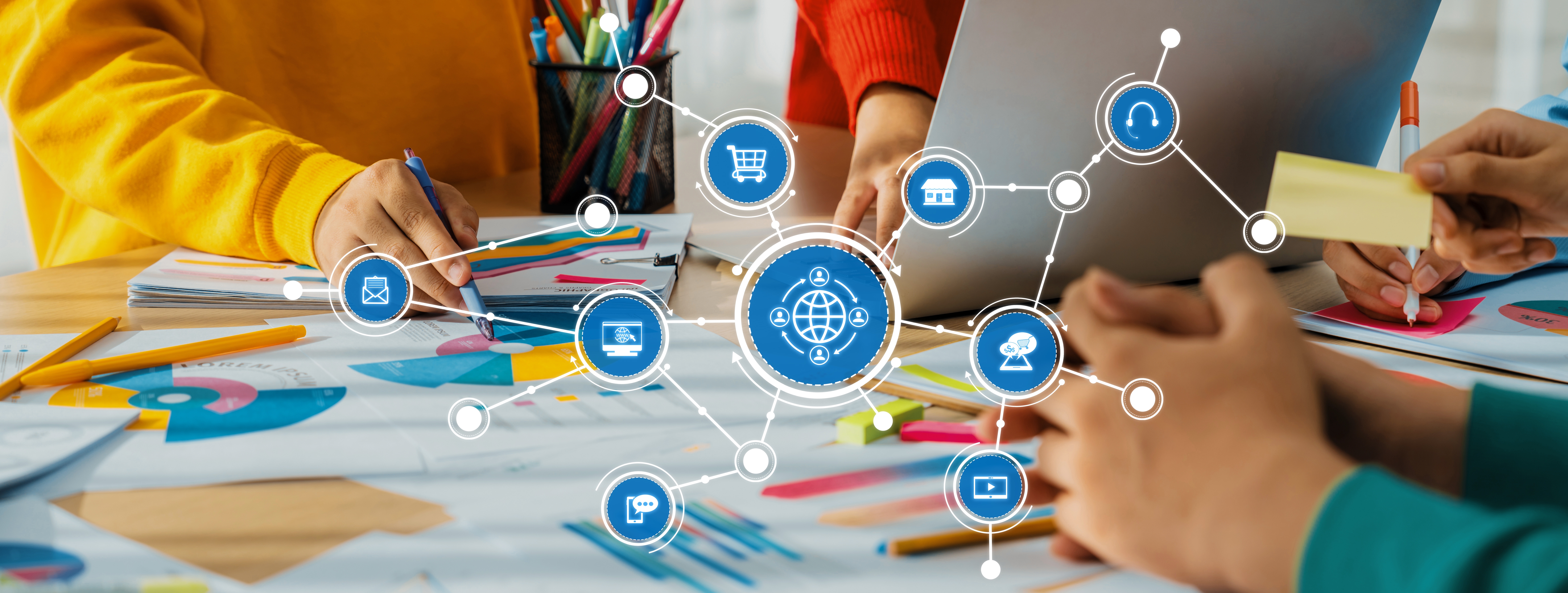 An office featuring hands planning about their customized strategies.