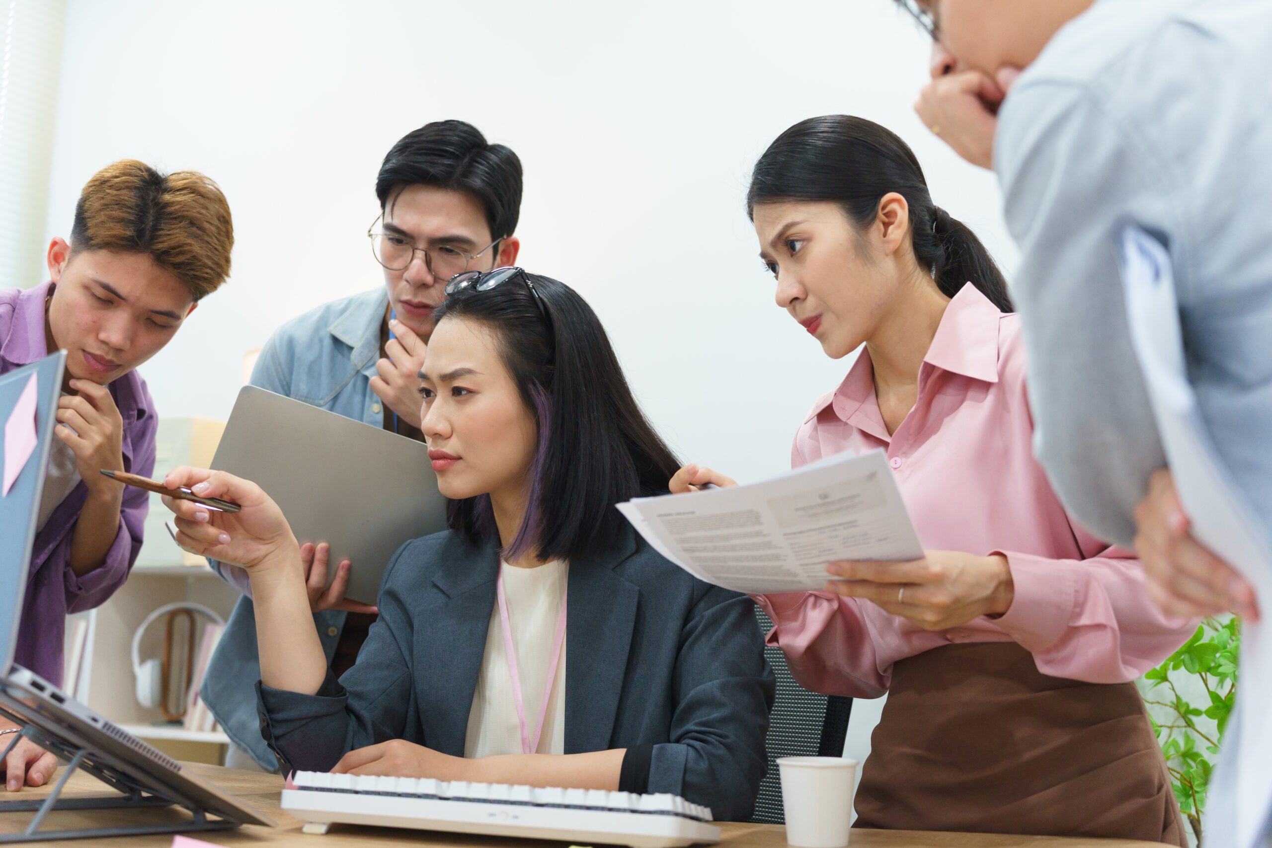 A sales team collaborating about their sales outreach.