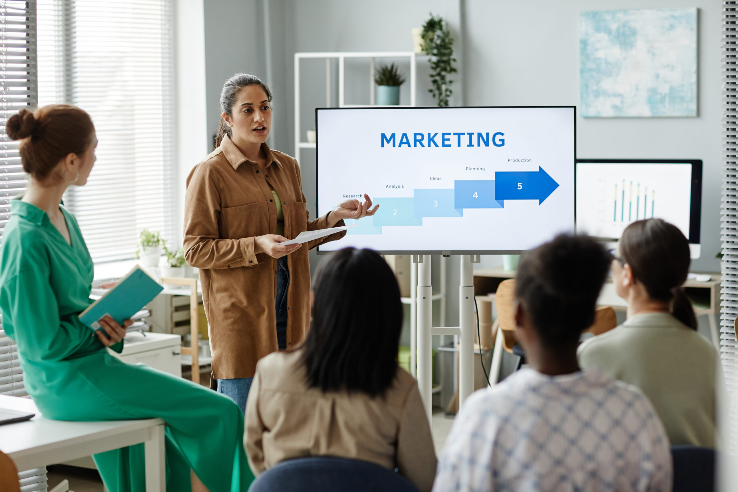 A sales team discussing about direct marketing strategies.